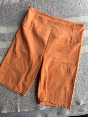 Girlfriend Collective High Rise 8” Women's bike Shorts in Horizon apricot orange